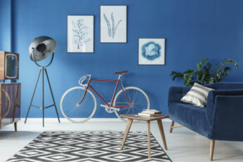 Cozy blue and white loft interior with sofa and bicycle