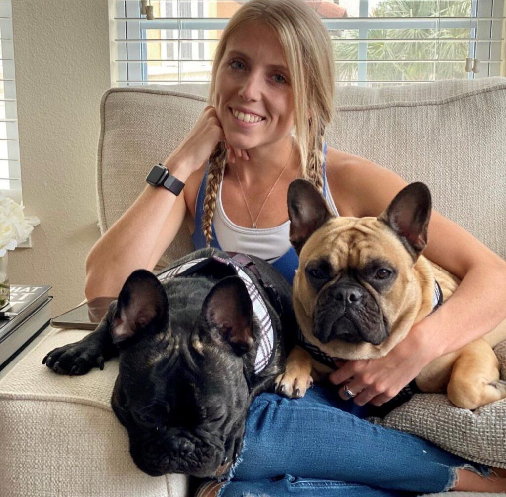 young woman and two Frenchie dogs